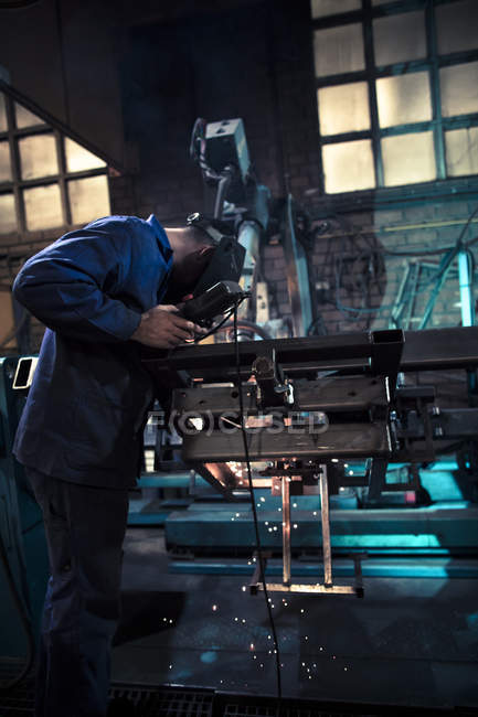 Welder welding metal with robot — Stock Photo