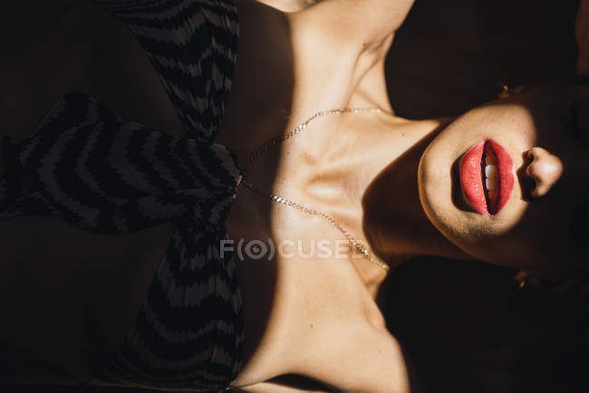 Close-up of lips and neck of beautiful young woman in sunlight — Stock Photo