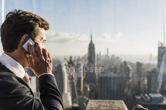 Etats-Unis, New York, homme parlant sur un téléphone portable sur le pont d'observation du Rockefeller Center — Photo de stock