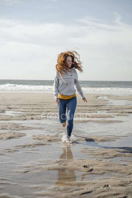 https://st.focusedcollection.com/14026668/i/650/focused_265365862-stock-photo-happy-woman-having-fun-beach.jpg