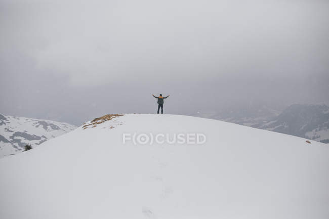 Austria, Kitzbuehel, back view of happy man enjoying snow-covered landscape — Stock Photo