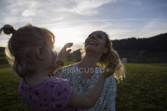 Austria, Tyrol, Walchsee, happy mother with daughter on an alpine meadow — Stock Photo