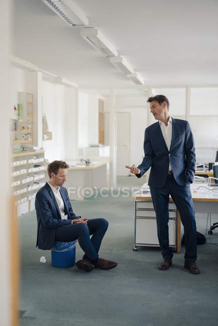 Manager Making Colleague Sitting On Wastepaper Basket Redundant Job Middle Aged Stock Photo 268301724