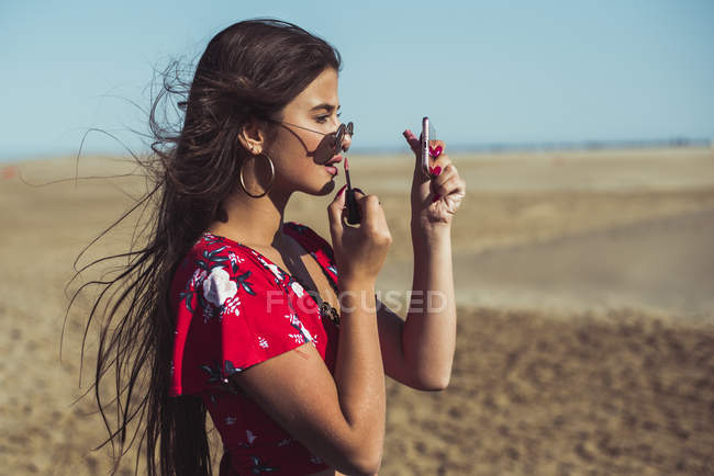 Teenager Mädchen Lipgloss am Strand auftragen — Stockfoto