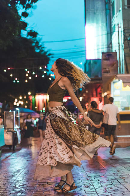 Tailândia, Bangkok, jovem mulher na cidade dançando na rua à noite — Fotografia de Stock