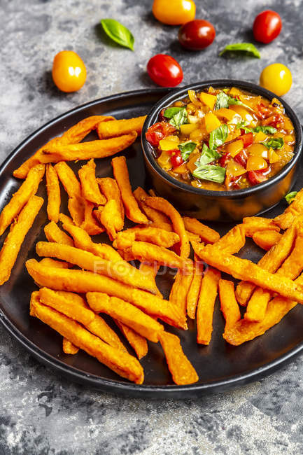 Homemade sweet potato fries and bowl of tomato basil dip — Stock Photo