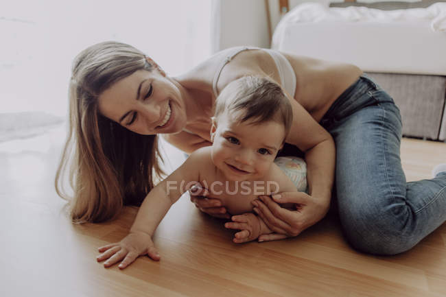 Mother and baby son playing and crawling on floor — brown hair, parent - Stock Photo | #268360580 Mother and baby son playing and crawling on floor — brown hair, parent - Stock Photo | #268360580