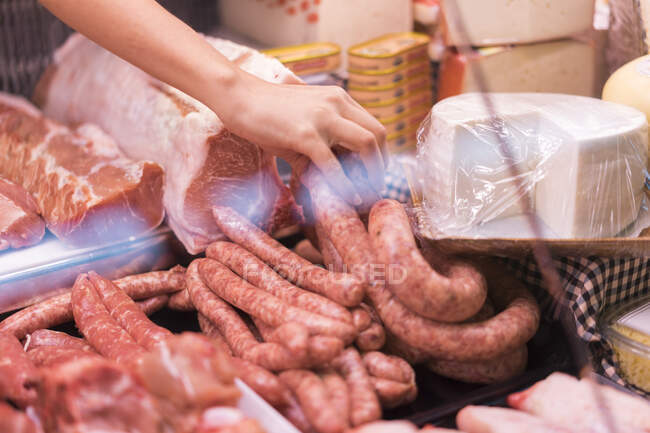 Female butcher with sausage — Stock Photo