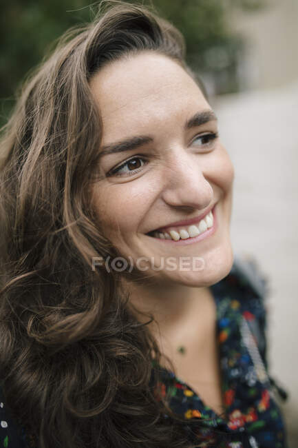 Портрет улыбающейся брюнетки на улице — стоковое фото