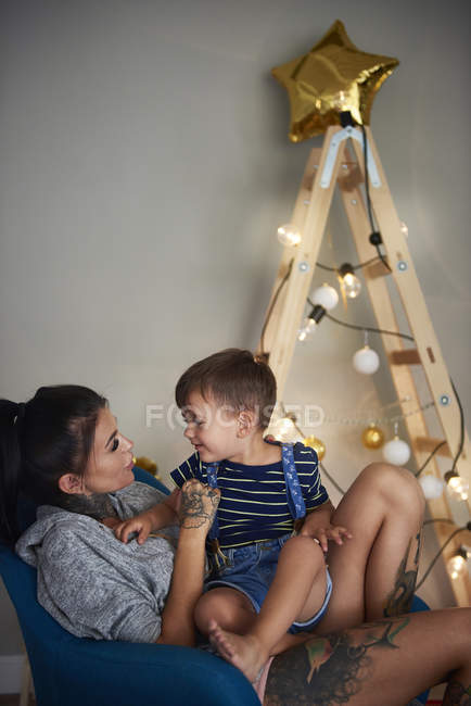Happy boy with his mother at home at Christmas time — Stock Photo