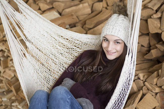 Portrait Of Smiling Young Woman Wearing Bobble Hat And Gloves