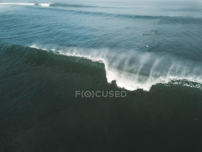 Indonesia, Bali, Aerial view of surfers, big wave — Stock Photo
