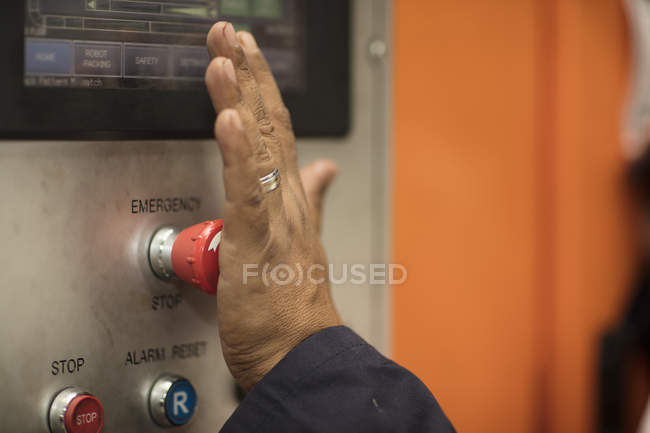 Worker using control panel, emergency button — Stock Photo