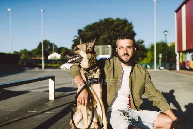 Portrait of young man with his dog — Stock Photo