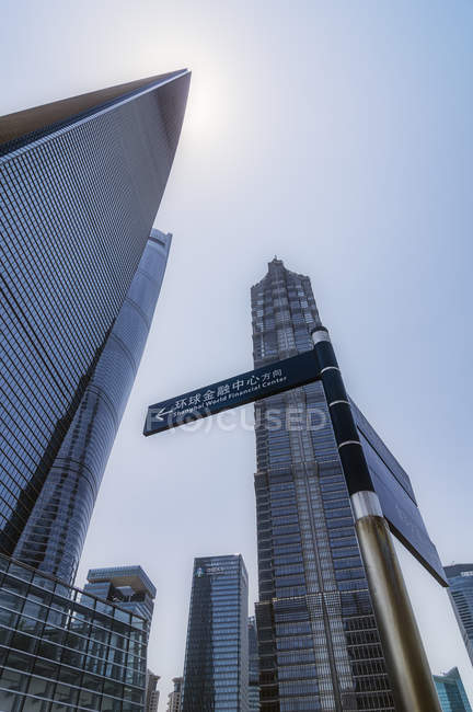 China, Shanghai, Lujiazui, skyscrapers and sign post at financial district — Stock Photo