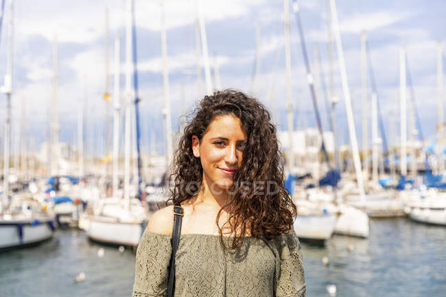Portrait of smiling teenage girl at a marina — Stock Photo
