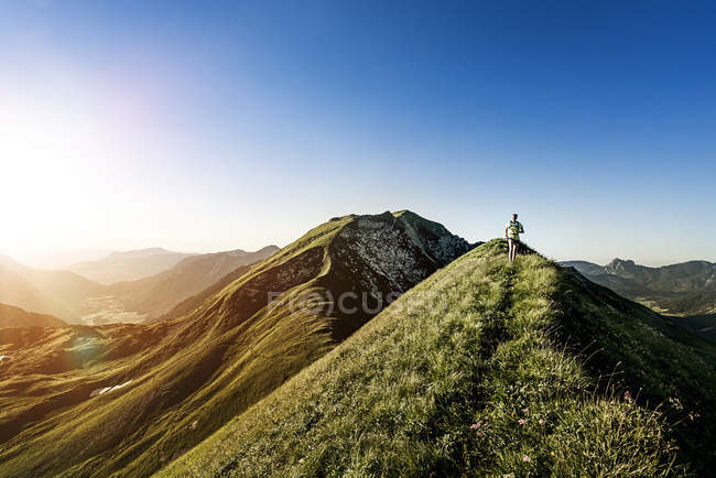 Germany, Allgaeu Alps, woman running on mountain ridge — Stock Photo