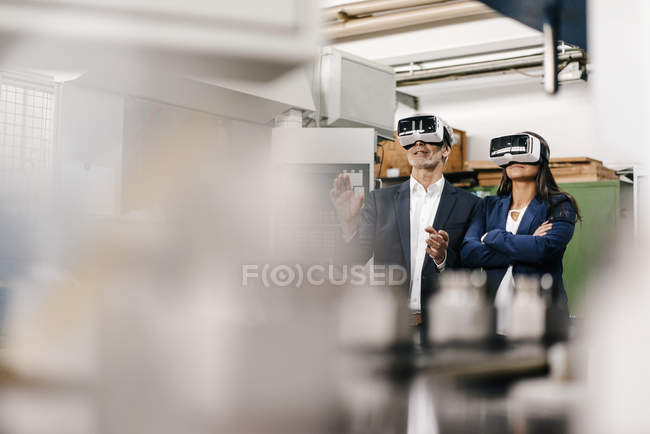 Business people in high-tech enterprise, using VR glasses — Stock Photo