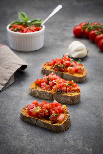 Bruschetta with tomato, basil, garlic and white bread — Stock Photo