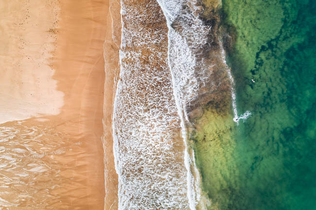 Spain, Asturias, Aerial view of surfers in the water on a beach — Stock Photo