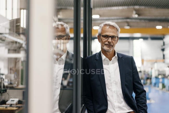Portrait of successful entrepreneur standing in company — Stock Photo