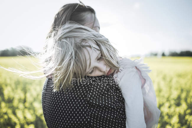 Retrato de menina nos braços da mãe no campo de estupro — Fotografia de Stock
