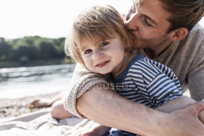 Portrait of father and son having fun at riverside — Stock Photo