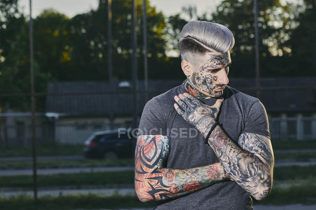 Portrait of tattooed young man outdoors — Stock Photo