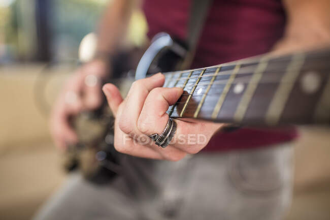 Primo piano della mano dell'uomo che suona la chitarra elettrica — Foto stock