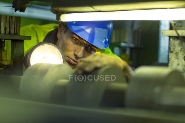 Engineer in industrial plant inspecting machines — Stock Photo