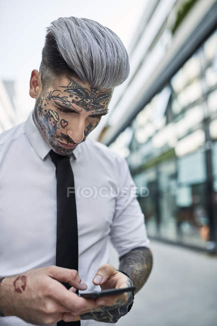 Young businessman with tattooed face walking in the city portrait  Waist  Up individuality  Stock Photo  270999752