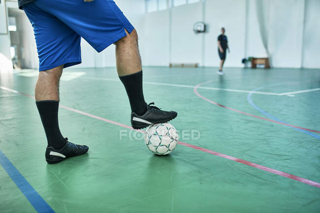 Close Up Of Indoor Soccer Player With Ball Training Match Stock Photo