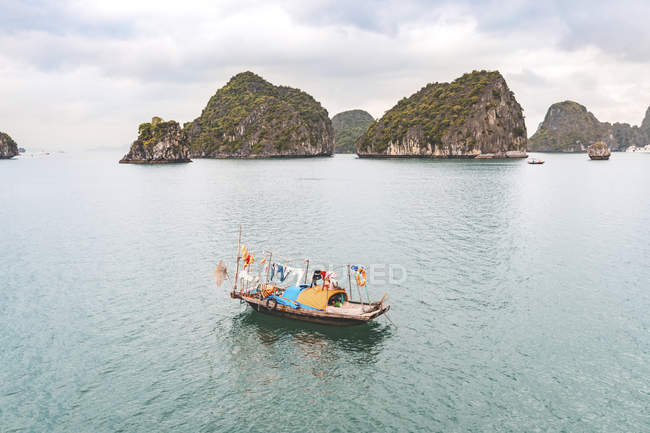 Vietnam, Ha Long bay, with limestone islands and small boat — Stock Photo