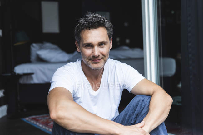 Portrait Of Confident Man In Pyjama At Home Sitting At French Window Bed Front View Stock Photo 274271796 focused collection