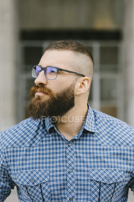 Portrait of bearded hipster businessman wearing glasses and plaid shirt —  dark hair, brown hair - Stock Photo | #274918426