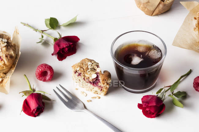 Raspberry muffin and glass of iced coffee — Stock Photo