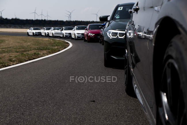 Cars in a row on racetrack — Stock Photo