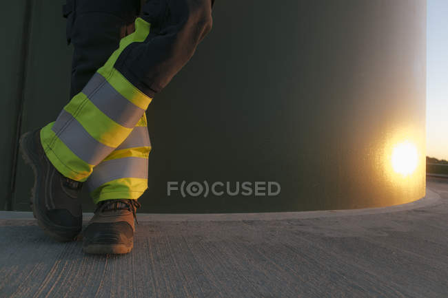 Cropped image of engineer standing at a wind turbine tower — Stock Photo