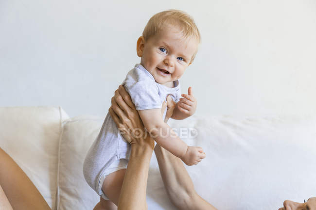 Portrait of happy baby girl held by her mother — Stock Photo