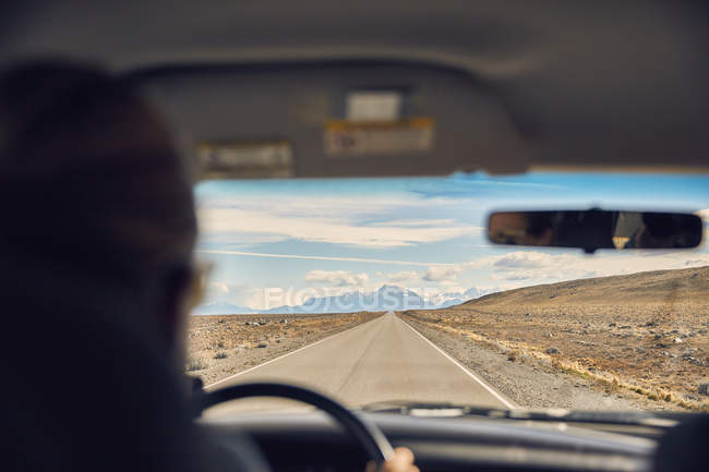 Argentina, Patagonia, El Chalten, woman driving camper on road towards Fitz Roy — Stock Photo