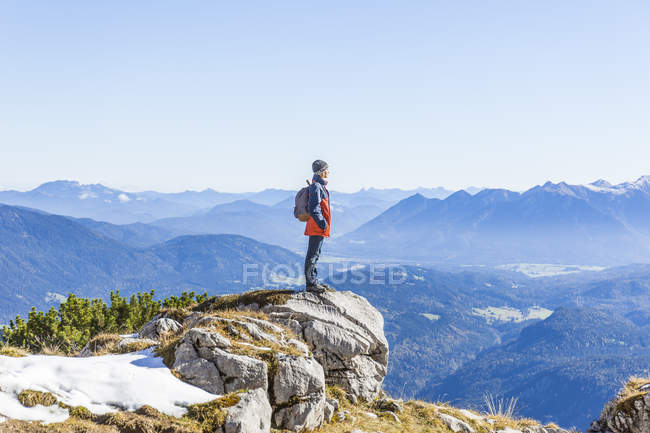 Germany, Garmisch-Partenkirchen, Alpspitze, Osterfelderkopf, female hiker on viewpoint looking at view — Stock Photo