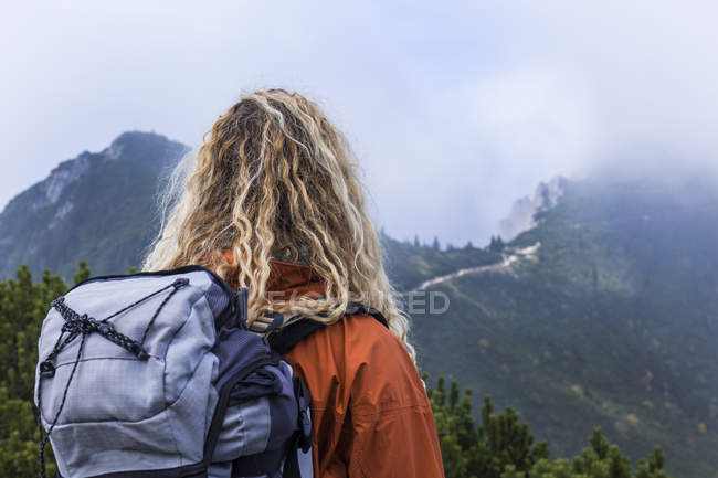 Junge Frau beim Wandern in den bayerischen Bergen mit Blick auf den Walchensee — Stockfoto