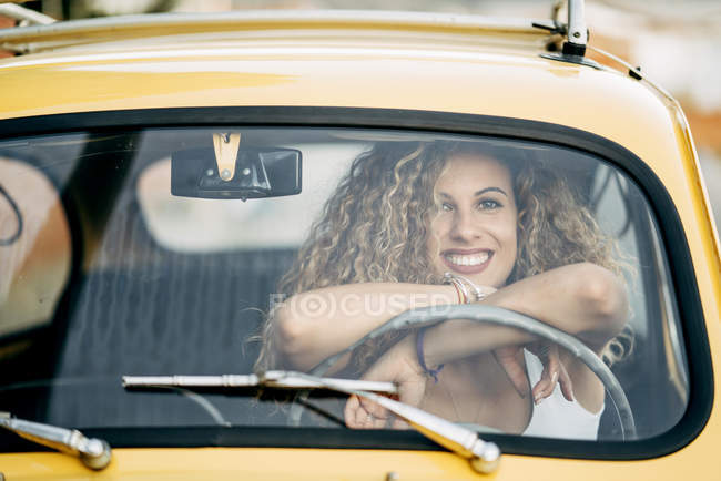 Portrait de femme blonde heureuse dans une voiture classique — Photo de stock