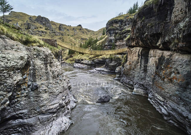 Peru, Quehue, donna che attraversa il ponte di corda — Foto stock