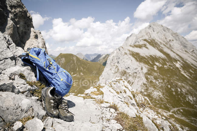 Austria, Tyrol, backpack and hiking boots in mountainscape — Stock Photo