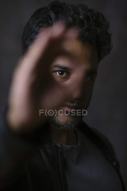 Retrato de un indio, mirando a través de los dedos - foto de stock