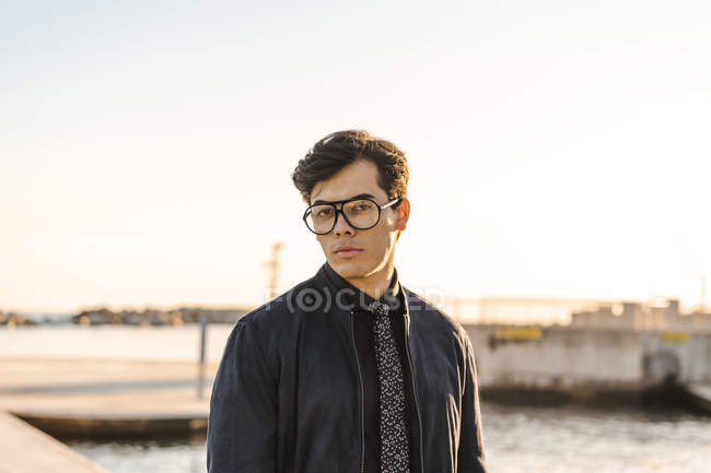 Portrait of fashionable young businessman wearing glasses and tie — Stock Photo