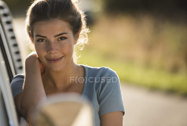 Красива жінка на дорозі поїздку з її кемпер, відпочиваючи на узбіччі дороги — стокове фото