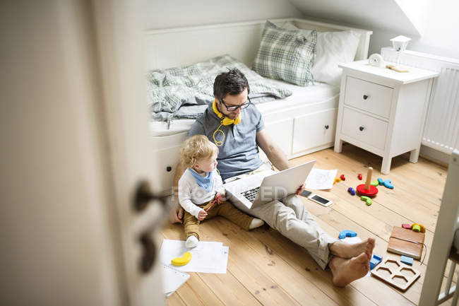 Father with his little son working from home — Stock Photo