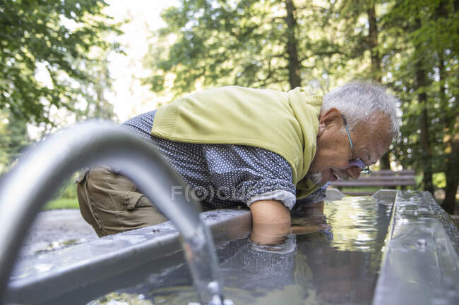 Старший мужчина во время лечения Kneipp, бассейн Kneipp, холодная ванна руки — стоковое фото